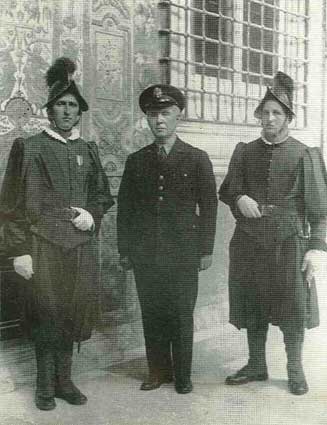 A well-traveled personality, Father Walsh poses with Vatican Guards.